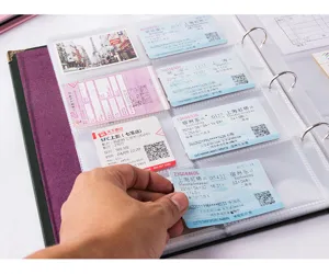 Close-up detail of ticket collection album binder, transparent PVC pockets, 3-inch photo slots.