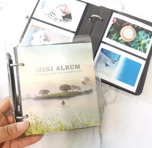 Detail view of mini loose-leaf photo album with transparent cover and landscape insert.