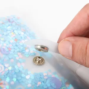 Close-up detail of transparent PP loose-leaf photo album binder snap button with glitter.