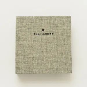 Fabric photo album detail shot, textured cover with Dear Moment design, perfect for storage.