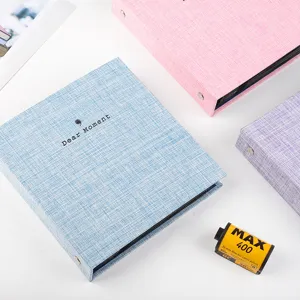 Detail shot of colorful fabric loose-leaf photo albums for organizing pictures and tickets.