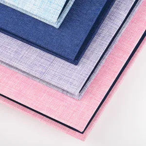 Detailed close-up view of stacked fabric textured photo albums in vibrant pastel colors for storage.