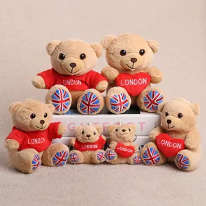 Detailed view of cute London souvenir teddy bear plush toys wearing red hoodies with flags.