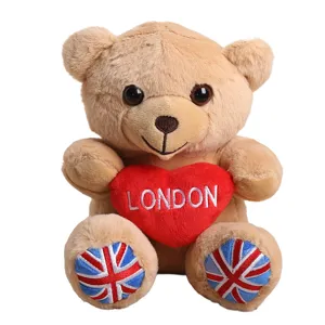 Cute plush teddy bear toy with London heart and UK flag foot pads, soft stuffed animal gift.