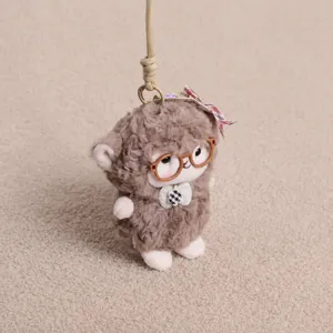 Cute plush lamb keychain detail, soft stuffed animal pendant with tiny glasses and ribbon.