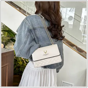 White quilted shoulder bag detail view with gold chain strap and elegant flap design.