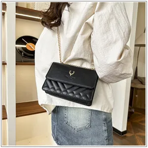 Stylish women's quilted black shoulder bag with gold chain strap and elegant deer logo.