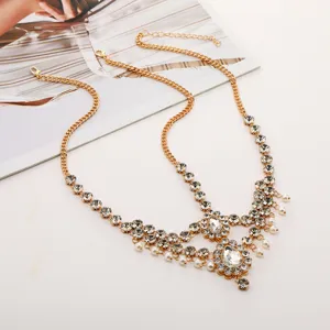 Exquisite rhinestone pearl forehead chain detail, bohemian gold hair accessory for women.