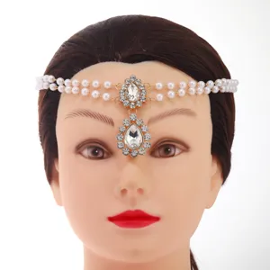 Close-up detail of bohemian pearl rhinestone forehead chain, exquisite crystal drop maang tikka