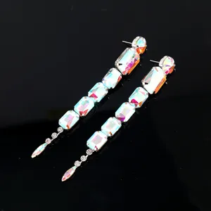 Exaggerated long dangle earrings featuring iridescent rectangular crystals for fashion look detail.