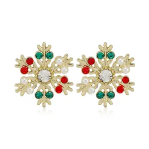 Pendientes de botón de copo de nieve navideños con pedrería de colores y perlas doradas.