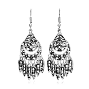 Close-up detail of vintage silver bohemian style dangle earrings with delicate filigree work.