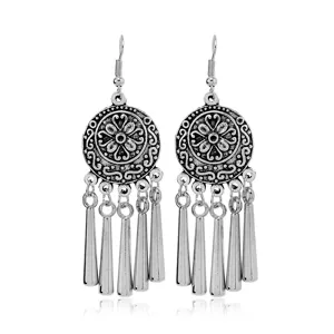 Vintage Bohemian ethnic silver dangle earrings with delicate cutout round patterns and fringe.