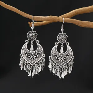 Vintage silver ethnic dangle earrings, bohemian hollow out long tassel jewelry detail shot.
