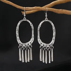 Vintage silver ethnic boho oval fringe dangle earrings detail shot showcasing intricate metalwork.