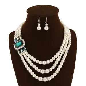 Elegante multi-layer kunstparel ketting set met prachtige groene kristal en oorbellen.