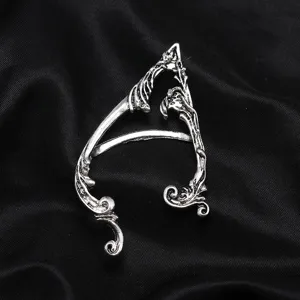 Detailed close-up shot of vintage gothic elf ear cuff, retro punk metal ear clip for women.