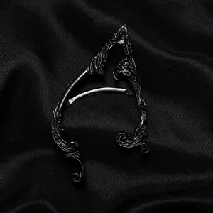 Detailed close-up of the vintage gothic elf ear cuff featuring intricate dark metal vine carvings.