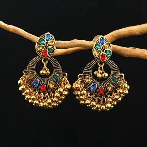 Detailed view of bohemian ethnic crystal gemstone beaded tassel earrings in vintage gold tone.