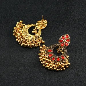 Close-up of vintage Indian ethnic bohemian gold-tone crystal beaded fringe earrings detail.