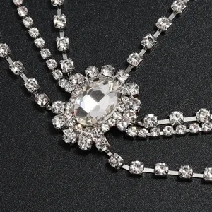 Close-up detail of multi-layer rhinestone forehead chain sparkling crystal hair accessory.