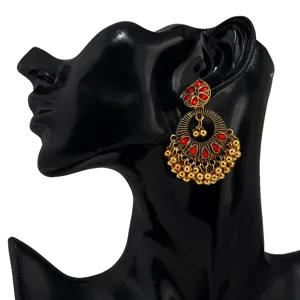 Detail shot of retro Indian ethnic style red gemstone crystal tassel earrings on display.