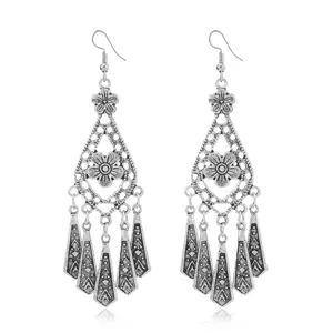 Vintage bohemian silver alloy long tassel earrings, intricate hollow flower drop design.