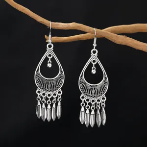 Bohemian vintage silver alloy teardrop tassel earrings for women, retro feather design jewelry.