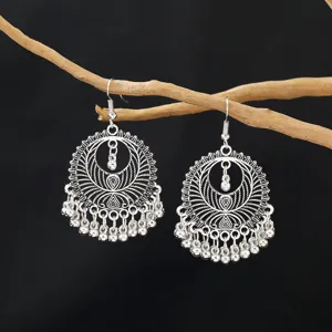 Vintage silver boho drop earrings with intricate hollow carved patterns and delicate dangling beads.