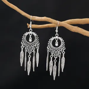 Vintage bohemian alloy dream catcher feather long tassel earrings detail view, silver tone.