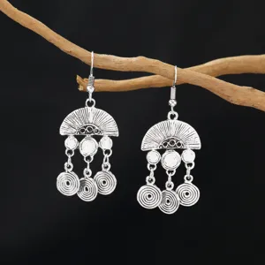 Vintage bohemian silver alloy long tassel earrings, exquisite geometric spiral drop design.