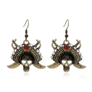 Vintage bronze skull pirate earrings with sparkling crystals and red rhinestone detail.