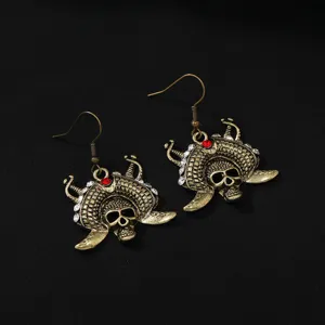 Vintage bronze alloy skull pirate earrings with sparkling rhinestones and red crystal accent.
