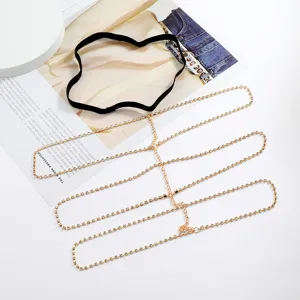 Detailed view of a multi-layer rhinestone thigh chain, sparkling crystal gold body jewelry.