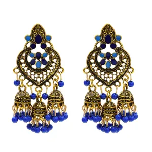 Close-up of vintage ethnic blue drop earrings with gold-tone alloy and beaded tassels.