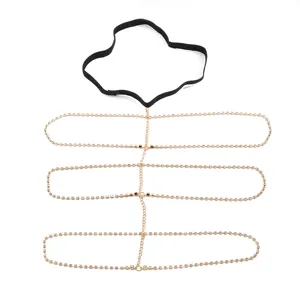 Rhinestone body chain detail showing multi-layer gold claw chain and black elastic band.