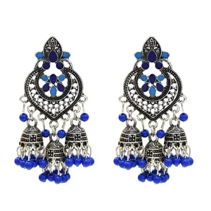 Vintage bohemian ethnic style blue enamel tassel jhumka earrings detailed close up view.
