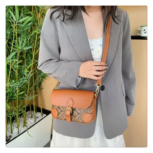 Close up view of retro monogram women crossbody shoulder bag with stylish brown color block.