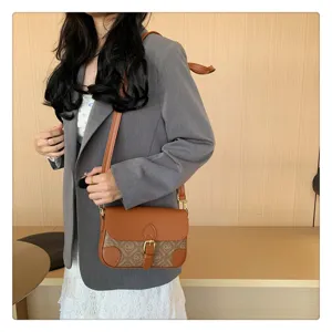 Vintage brown monogram crossbody shoulder bag for women, retro flap design with buckle.
