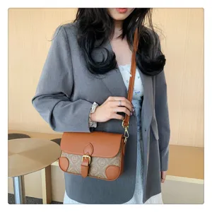 Vintage colorblock shoulder bag with flap design, monogram print canvas and chic buckle closure.