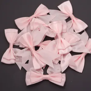 Pink double layer polyester swallowtail bow detail shot for diy craft and gift wrapping.