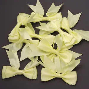 Yellow polyester double layer swallowtail bows for DIY hair clips and gift packaging.