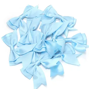 Close-up detail of light blue satin ribbon bows, smooth texture, perfect for DIY craft accessories.