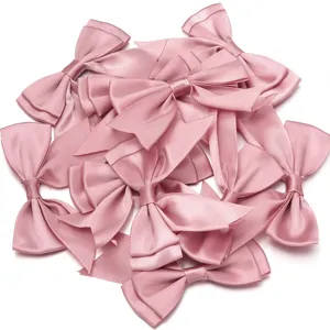 Close-up of pink double-layer satin swallowtail ribbon bows for DIY craft and gift wrapping.