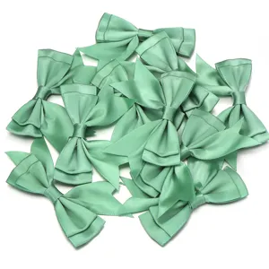 Close-up detail of sage green polyester double-layer swallowtail ribbon bows for DIY craft.