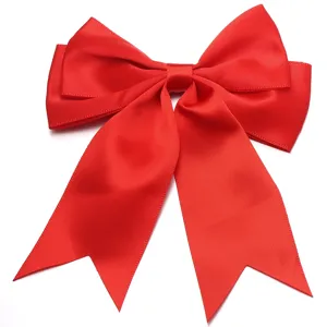 Close-up of bright red satin bow ribbon, smooth texture and swallowtail detail for DIY hair clips.