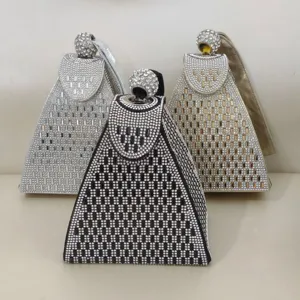 Detail shot of luxury rhinestone evening bags in silver, black and gold pyramid design.