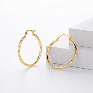 Close-up detail shot of gold-plated sterling silver smooth hoop earrings with secure clasp.