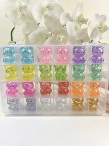 Detailed close-up of sparkling glitter clear bear toys arranged neatly in a transparent box.
