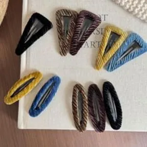 Close-up of vintage velvet snap hair clips in multiple colors, side bangs styling accessory.
